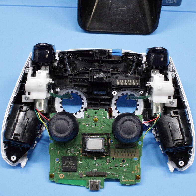 Open DualSense controller and circuit board during repair